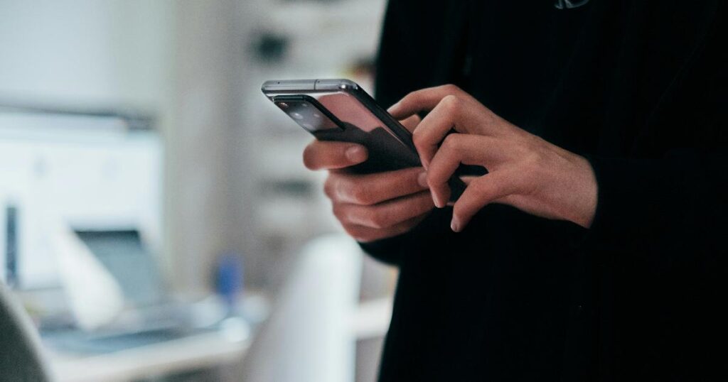 A person struggling to complete a digital government form on a smartphone with poor connectivity, illustrating digital government usability issues