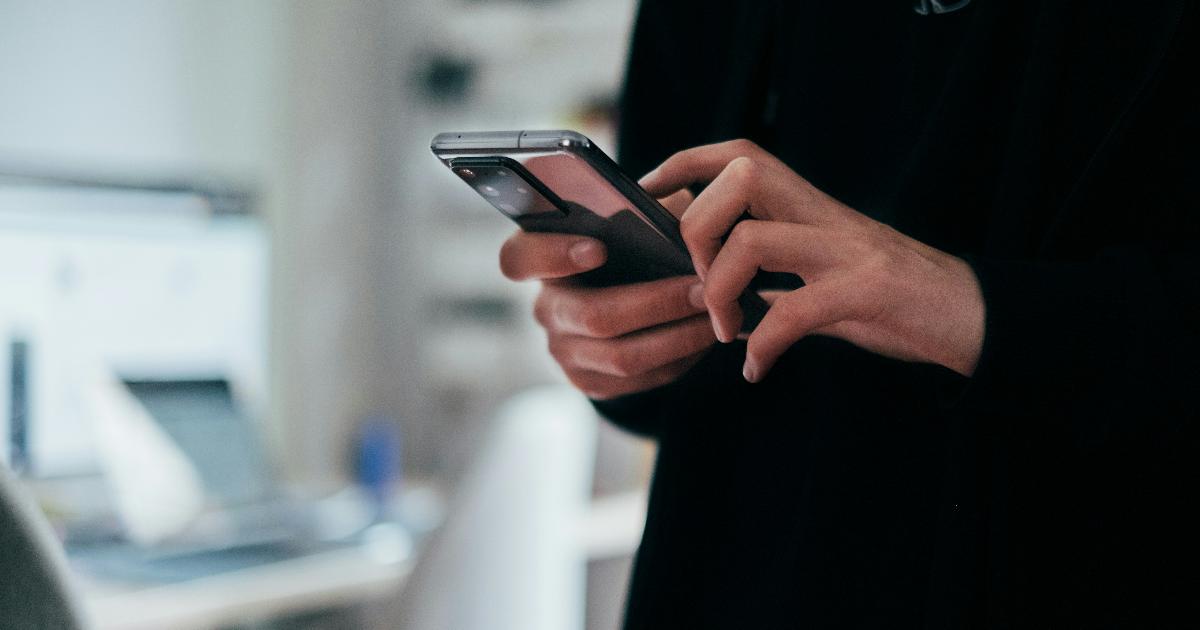 A person struggling to complete a digital government form on a smartphone with poor connectivity, illustrating digital government usability issues