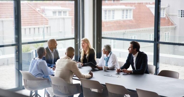 A cybersecurity CISO discussing operational resilience in a boardroom with executives