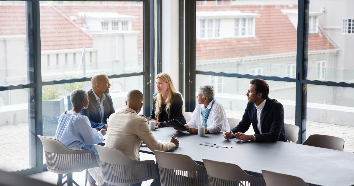 A cybersecurity CISO discussing operational resilience in a boardroom with executives
